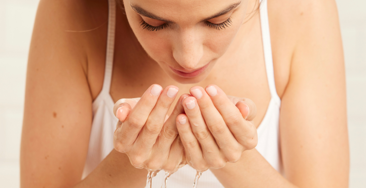 Woman cleansing her skin