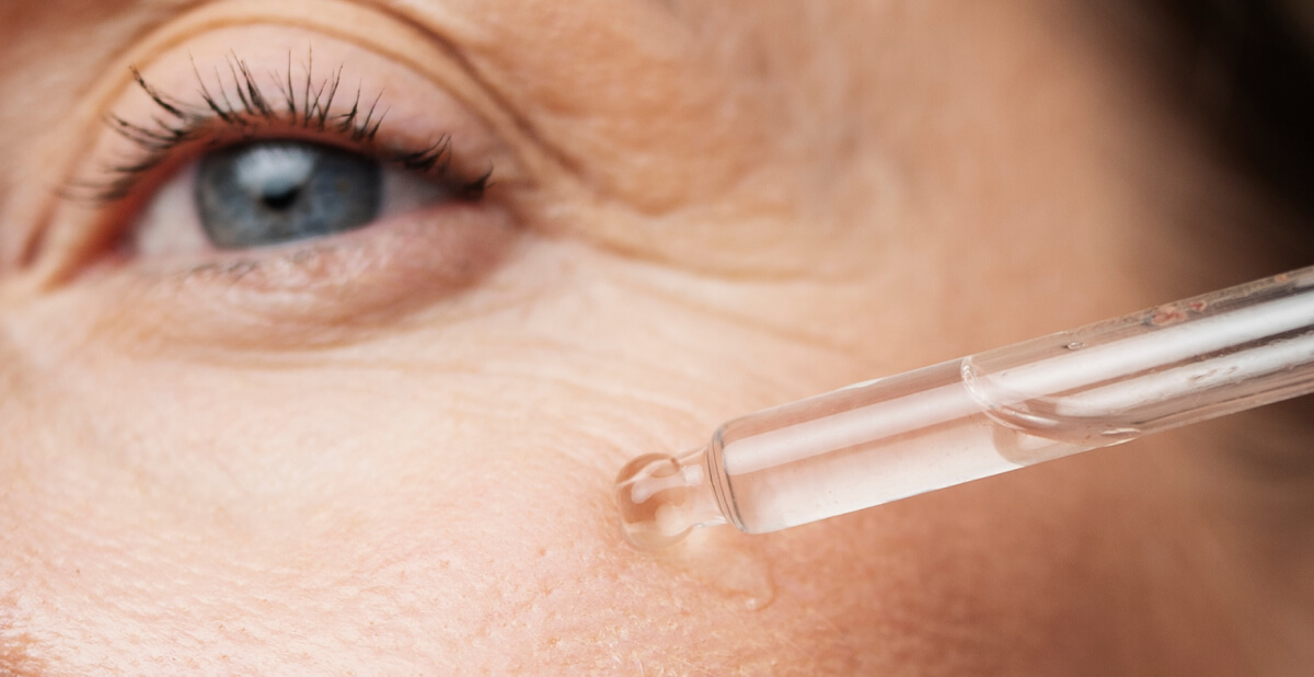 Woman applying antioxidant serum