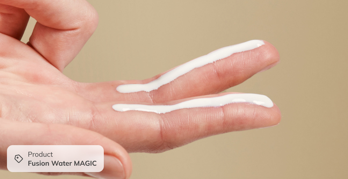 Close-up of fingers with lightweight cream texture, showing daily winter skincare application for hydration and skin comfort